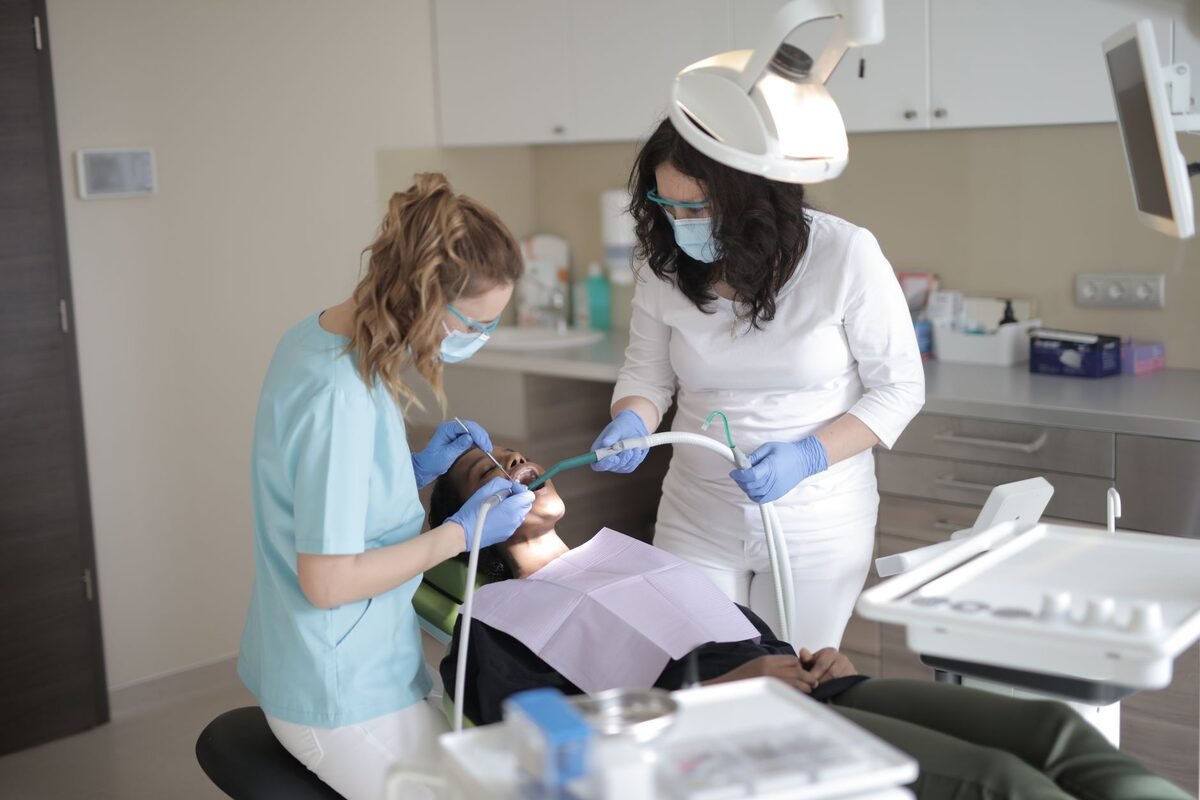 Dentist examining a patient's gums during a periodontal treatment visit